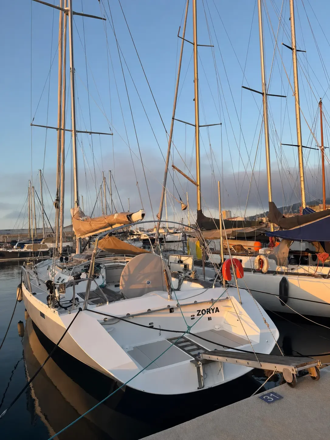 ZORYA moored at berth 31 in Sète at sunrise, name visible on the transom